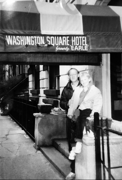 Archival photograph of two people outside the Washington Square Hotel entrance