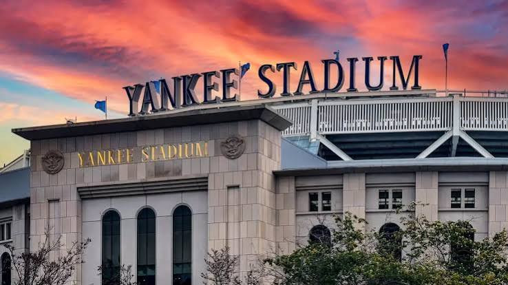 Yankee Stadium exterior beneath a colorful sunset sky
